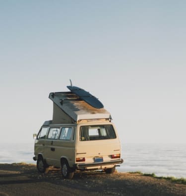 How is van life evolving? A camper van on the water's edge