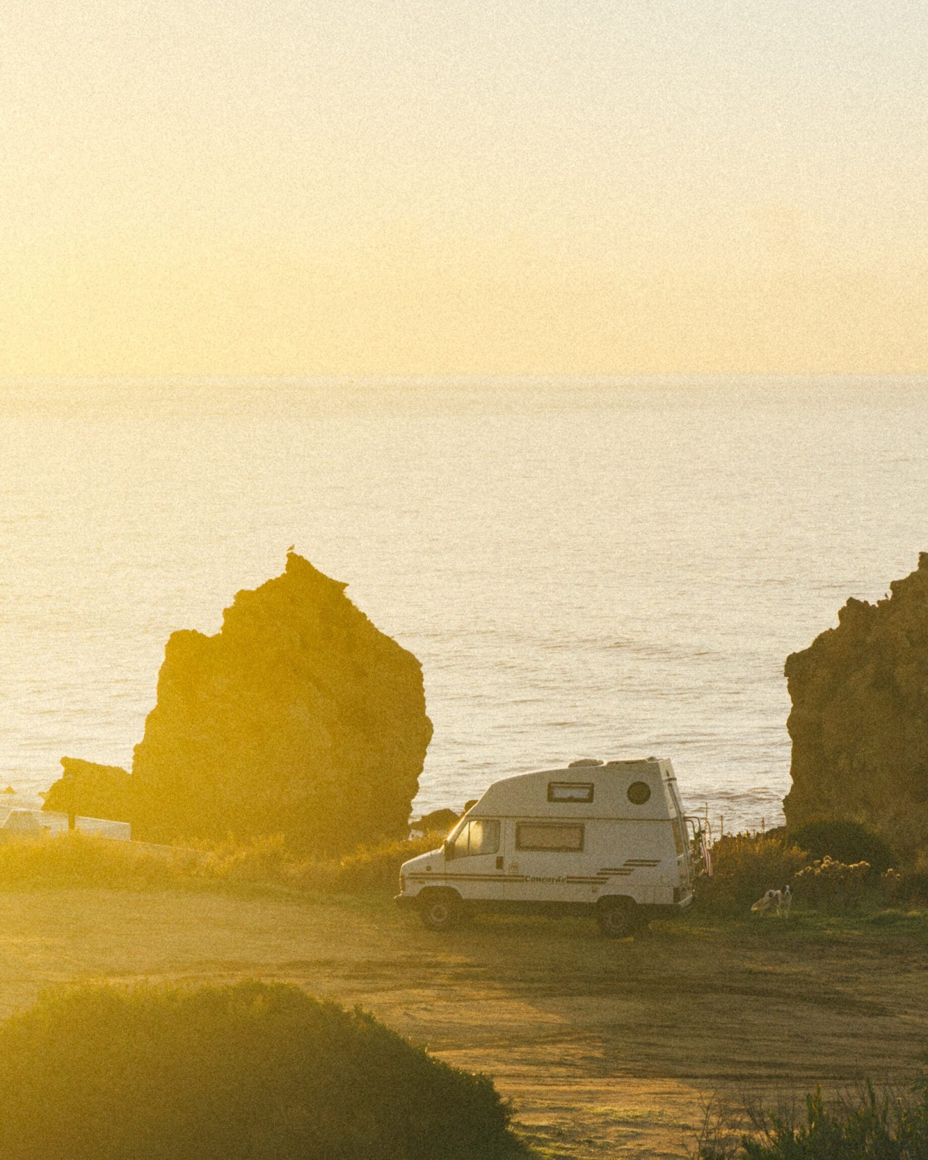 How is van life evolving? A fan against a hazy yellow sunset