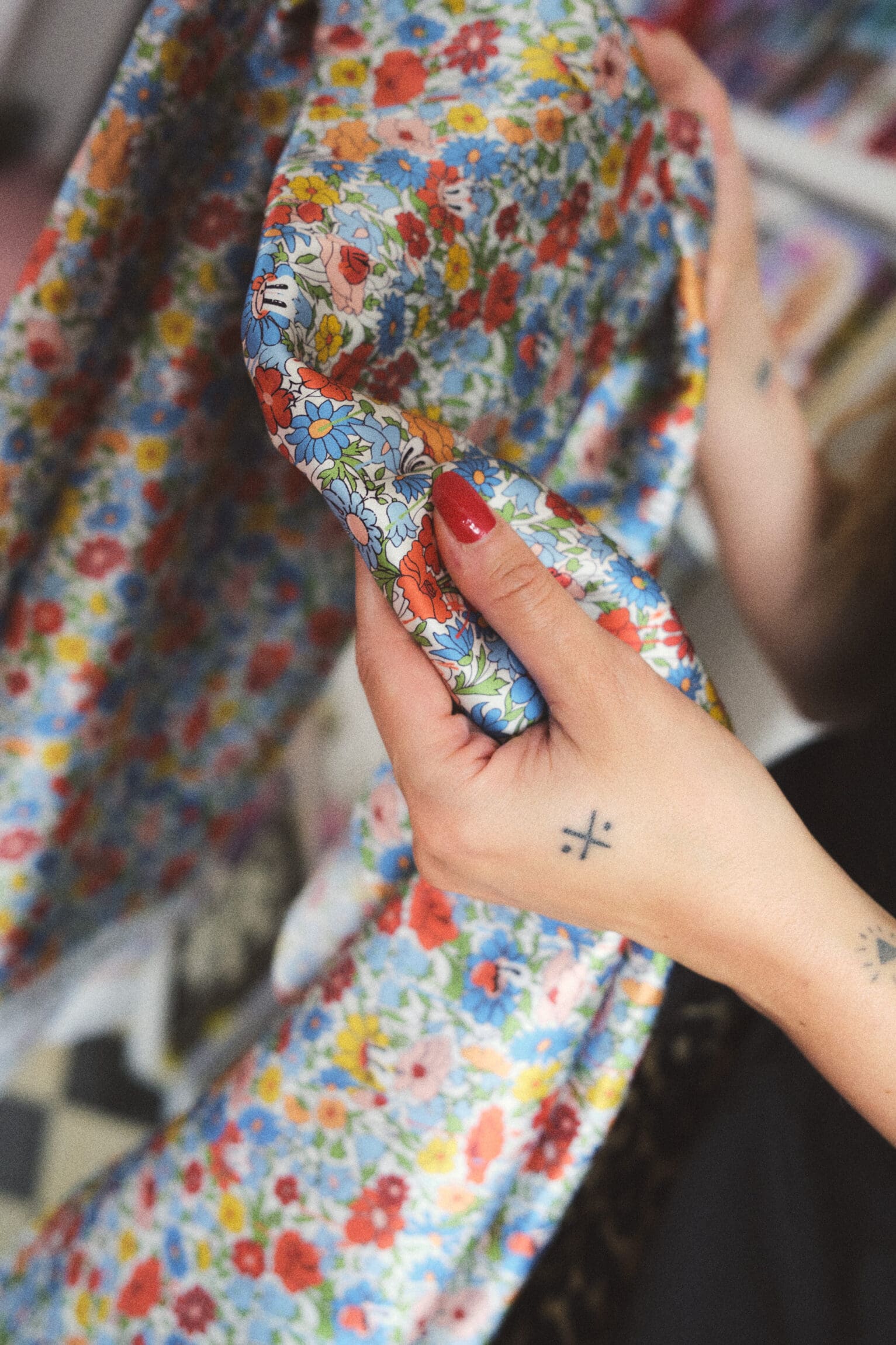Hattie Stewart's Liberty fabric, featuring cartoon-like characters amongst the flowers