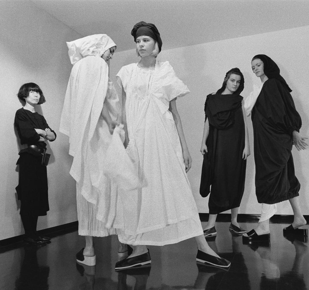 Rei Kawakubo with models wearing Comme des Garçons, published in People (December 1983). Courtesy Metropolitan Museum of Art; photo: Takeyoshi Tanuma