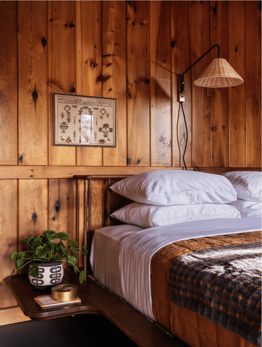 Where to stay in the Catskills | a shaker-style wooden cabin with bed in view