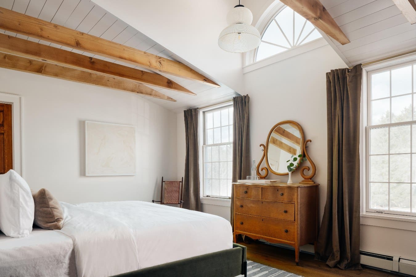 A serene bedroom in a palette of wood and white at Hotel Lilien, Tannersville