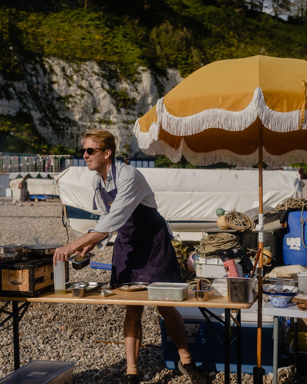 The best farm-to-table restaurants in the UK | Preparing dinner on a beach near Glebe House.