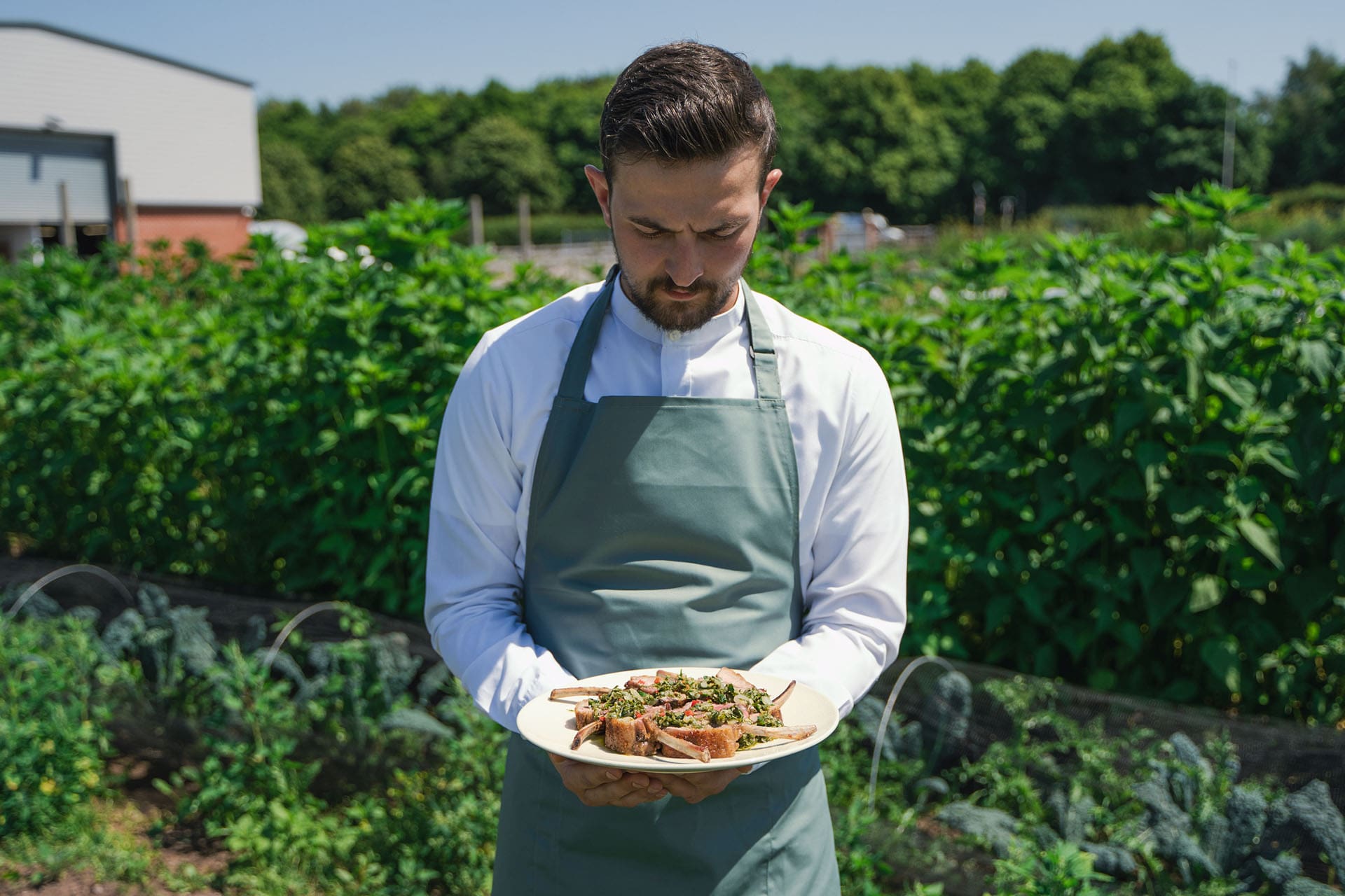 Chef shows off the dish he made from ingredients grown on the farm