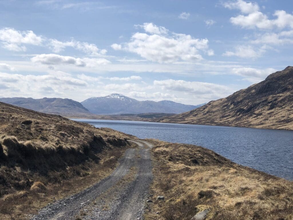 A complete guide to bikepacking in the UK | The gravel road along Lochan na h-Earba, a section of the Badger Divide. 