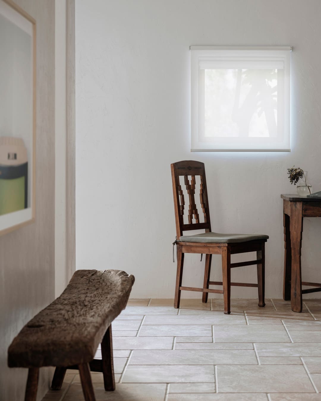 a wooden chair against a white wall at Sisan Shuanglang Hotel Dali