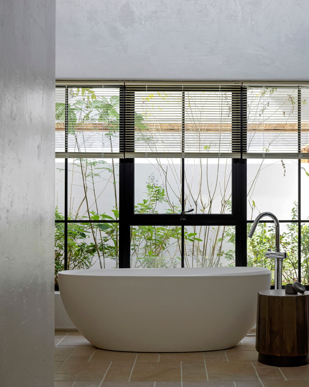 The rise of rural travel in China | a white bathtub against a window at Sisan Shuanglang Hotel Dali