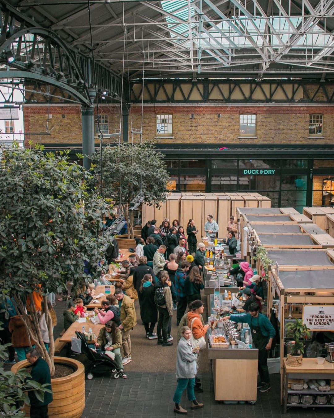 The best restaurants in Spitalfields | food stalls at Old Spitalfields Market beneath a lofty industrial ceiling