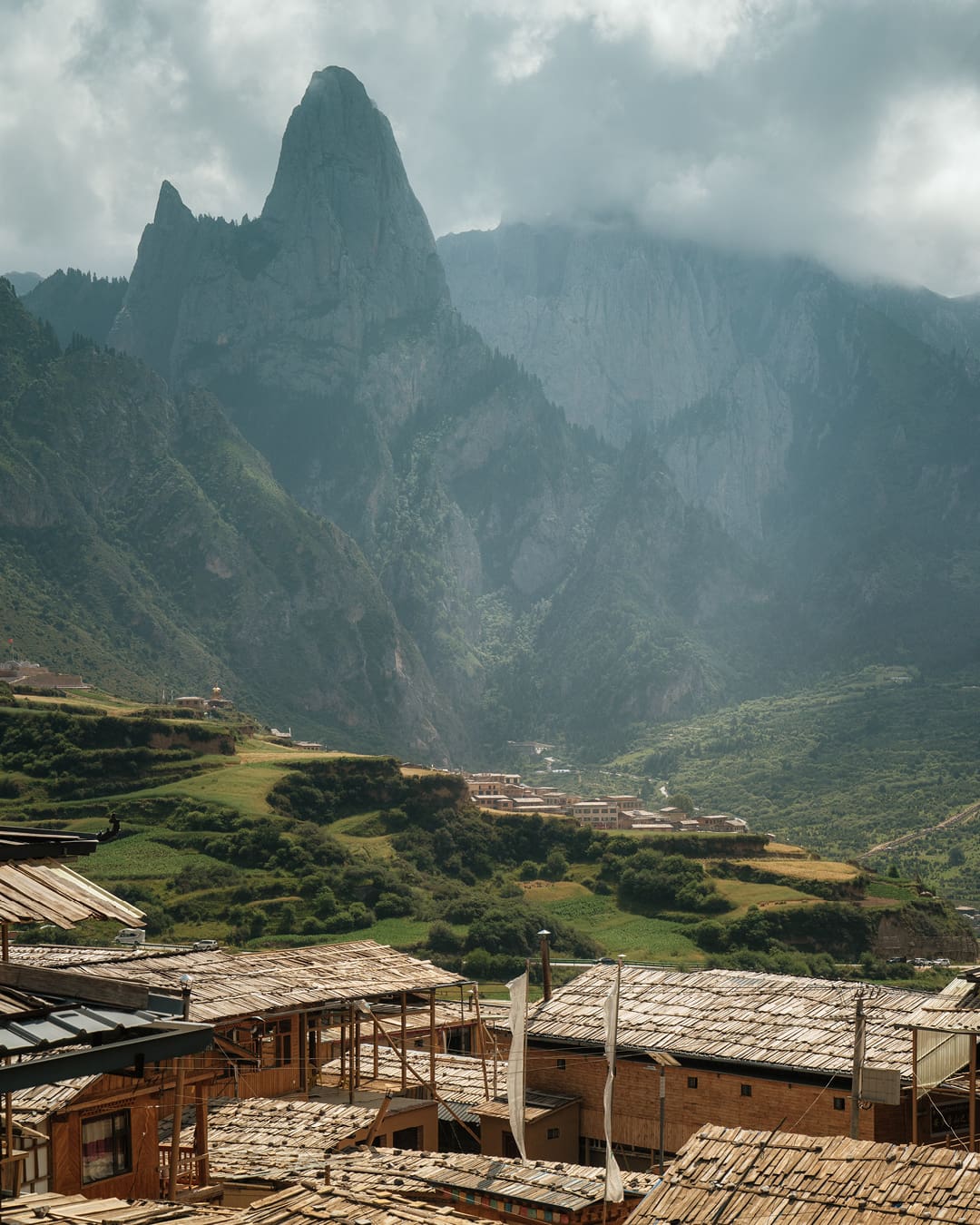 Mountains preside over a traditional Tibetan village