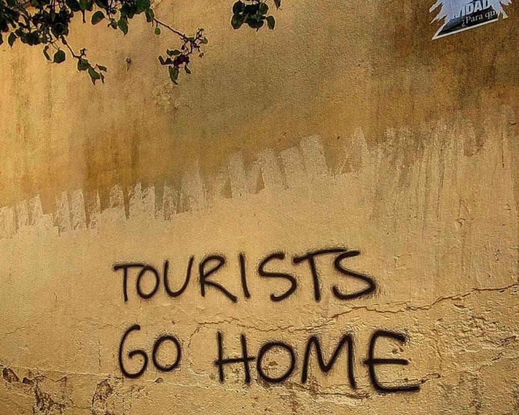 Overtourism in Europe | Graffiti in Barcelona, urging tourists to 'go home'. 