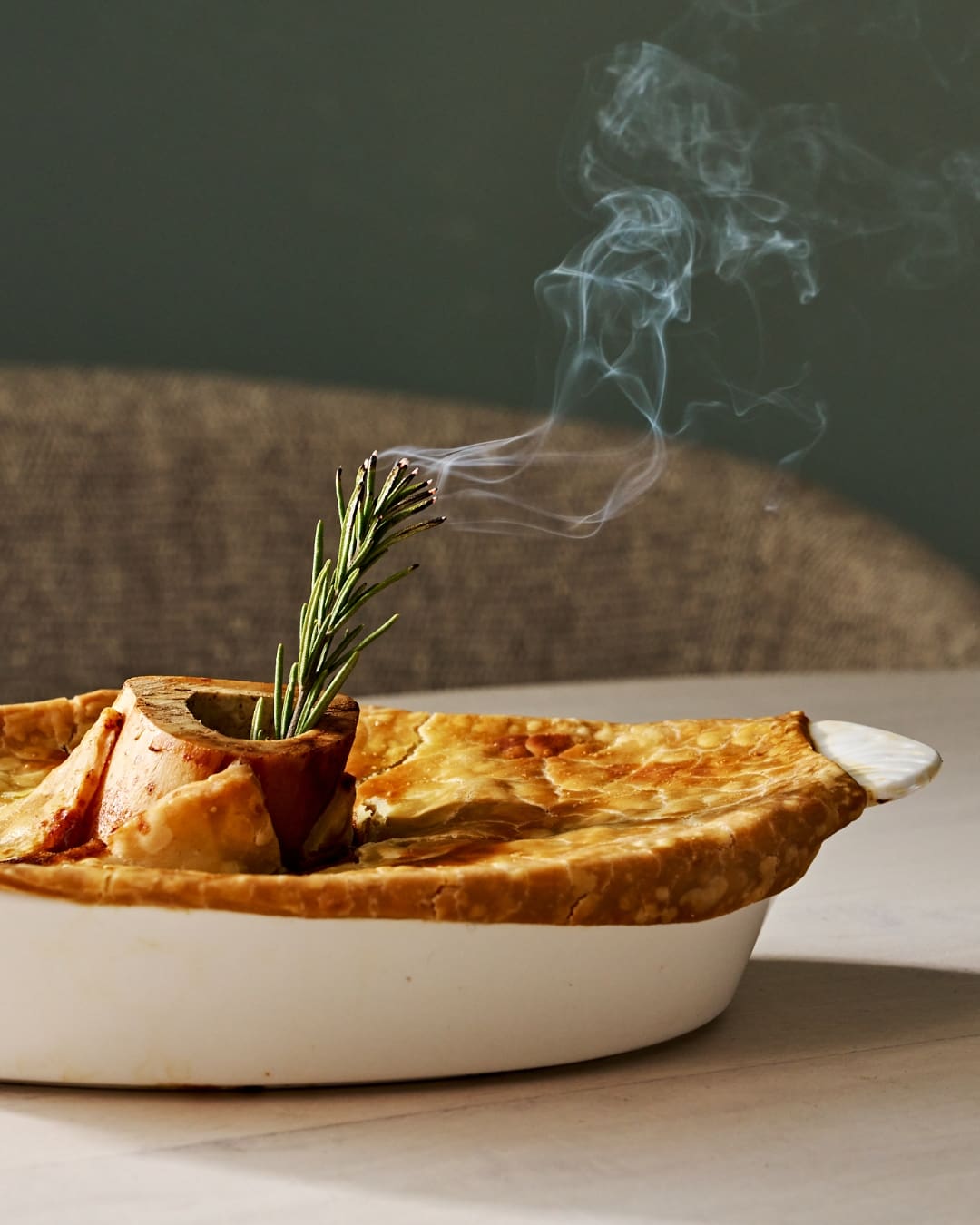 Hokkaido style beef pie topped with bone marrow and a smoking rosemary sprig