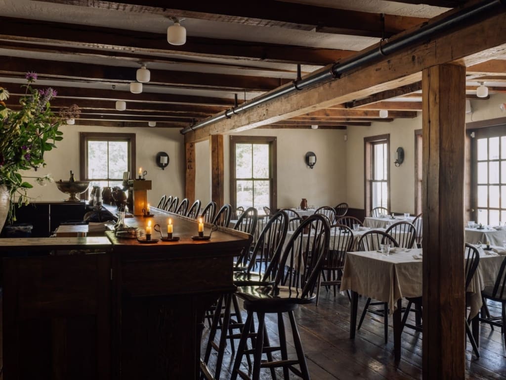 The best restaurants in Hudson NY | the atmospheric dining room at Stissing House with exposed wooden beams