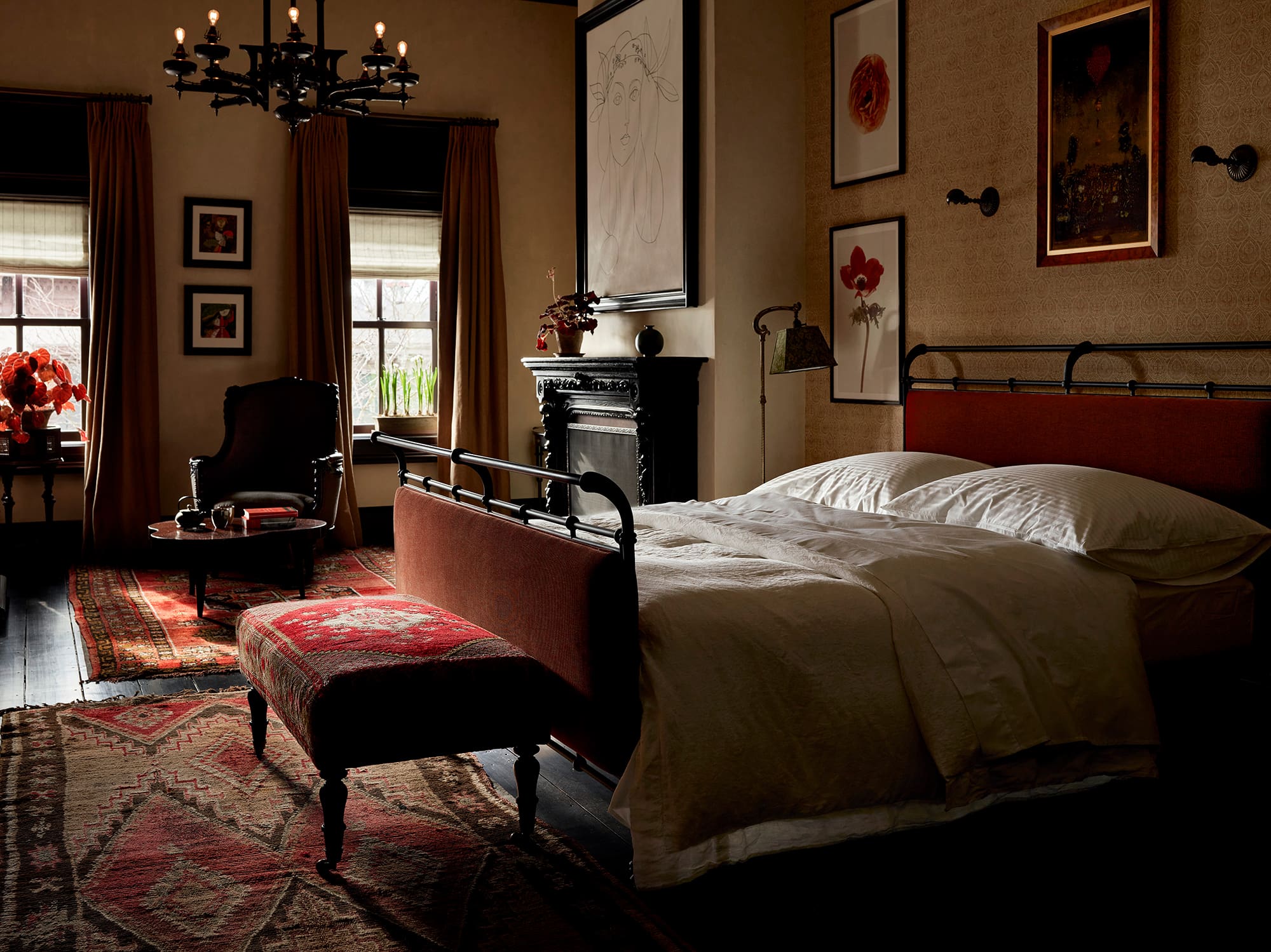 The best hotels in Hudson NY | a sumptuous room at The Maker with a bed, curated artwork and atmospheric light