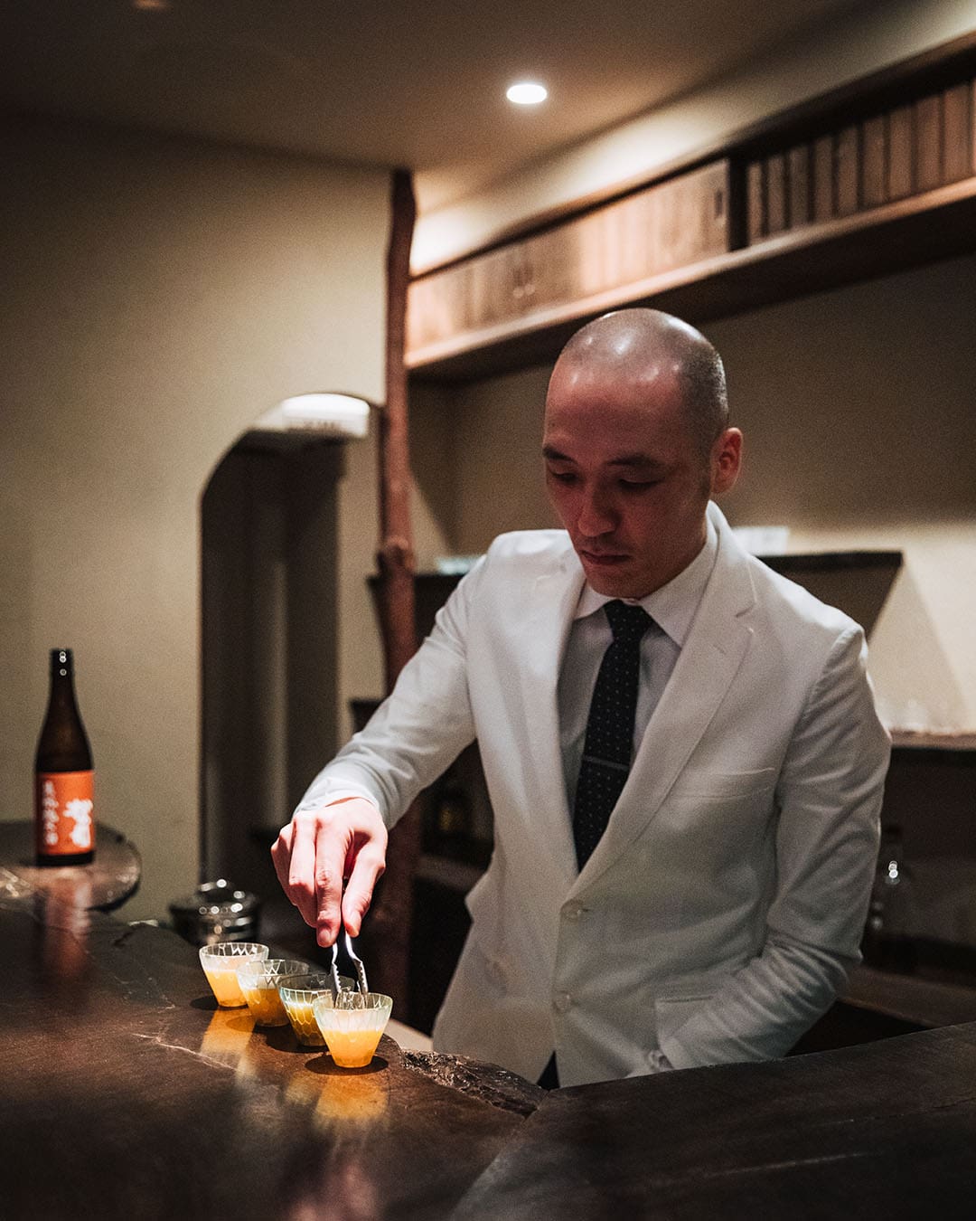 Master mixologist Gen Yamamoto in a white blazer