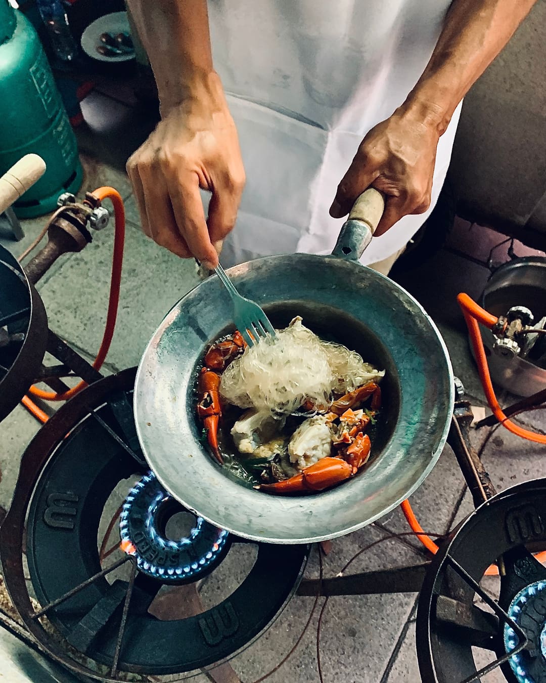 street food in bangkok | A man cooking jumbo prawns on an open air wok at Somsak Pu Ob