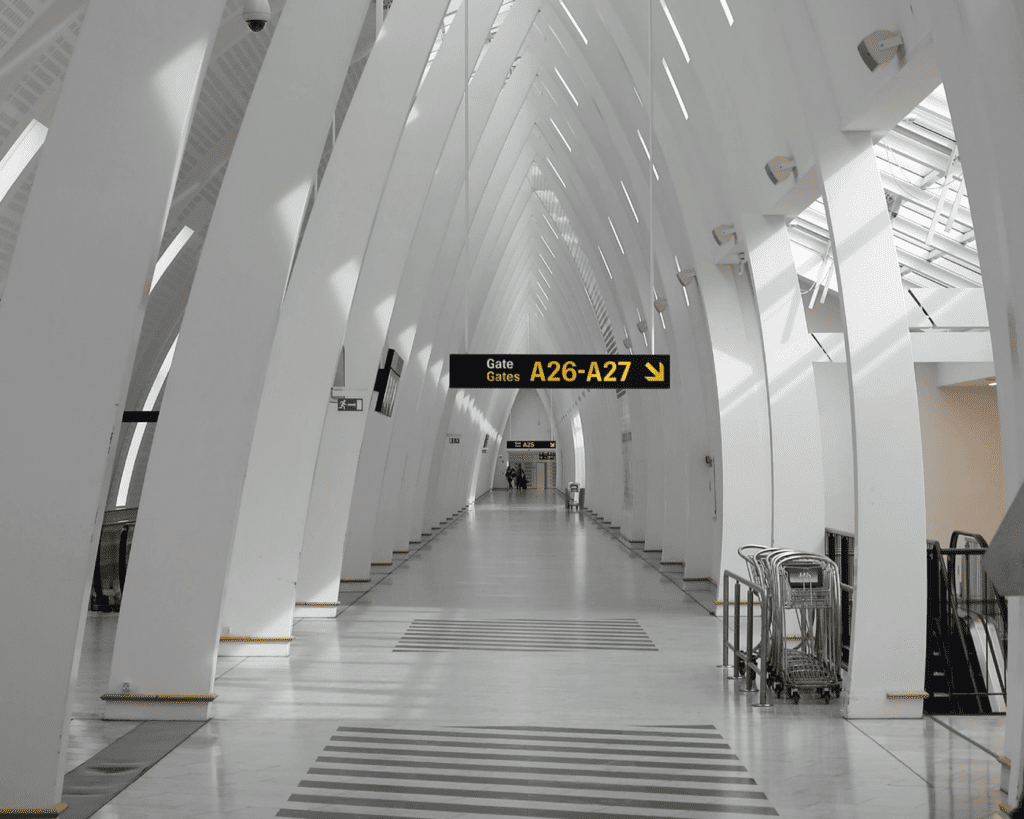 An all-white passageway at Copenhagen airport, photography by J. Brouwer