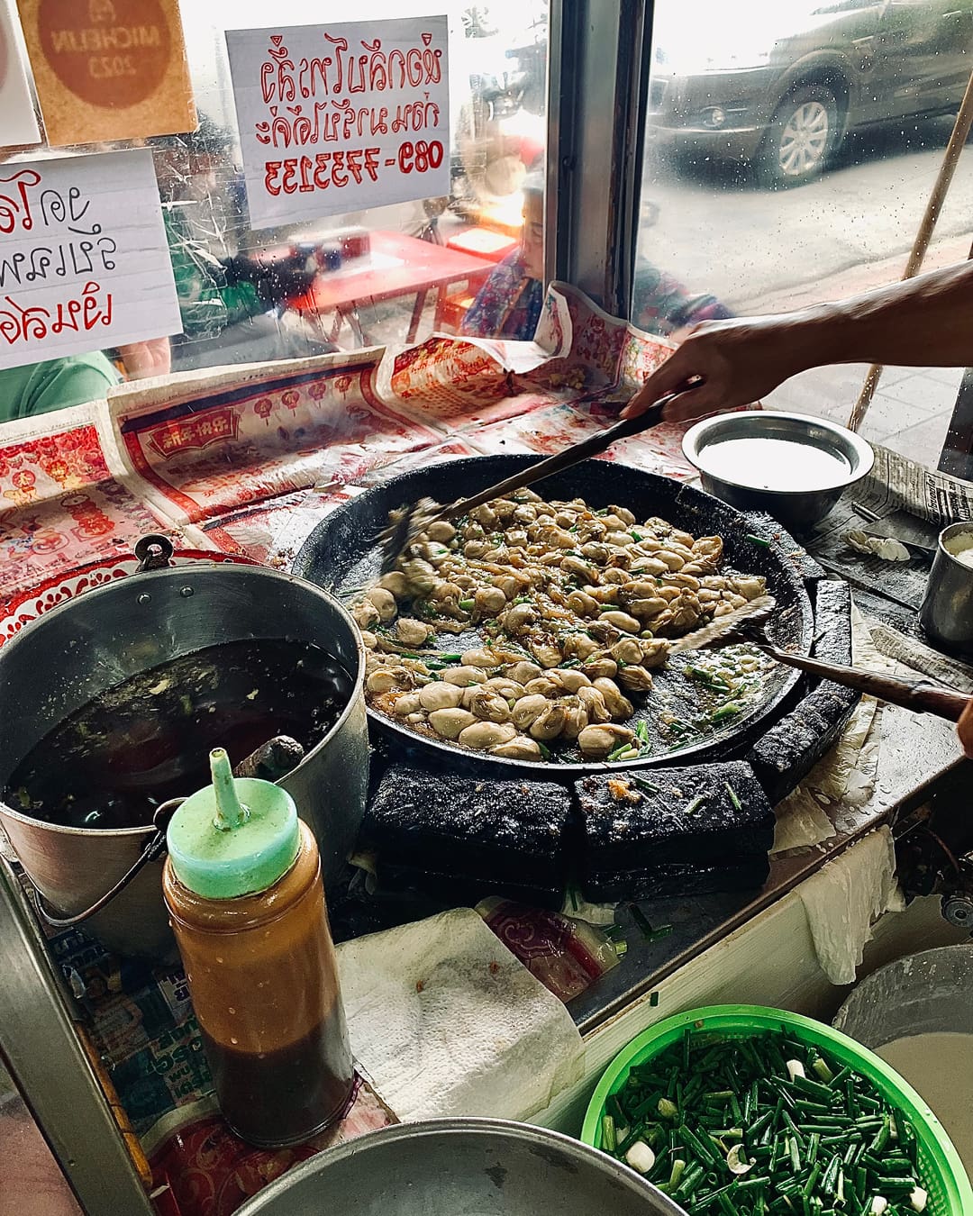 The best street food in. Bangkok | a woman cooking at Nai Mong Hoi Tod