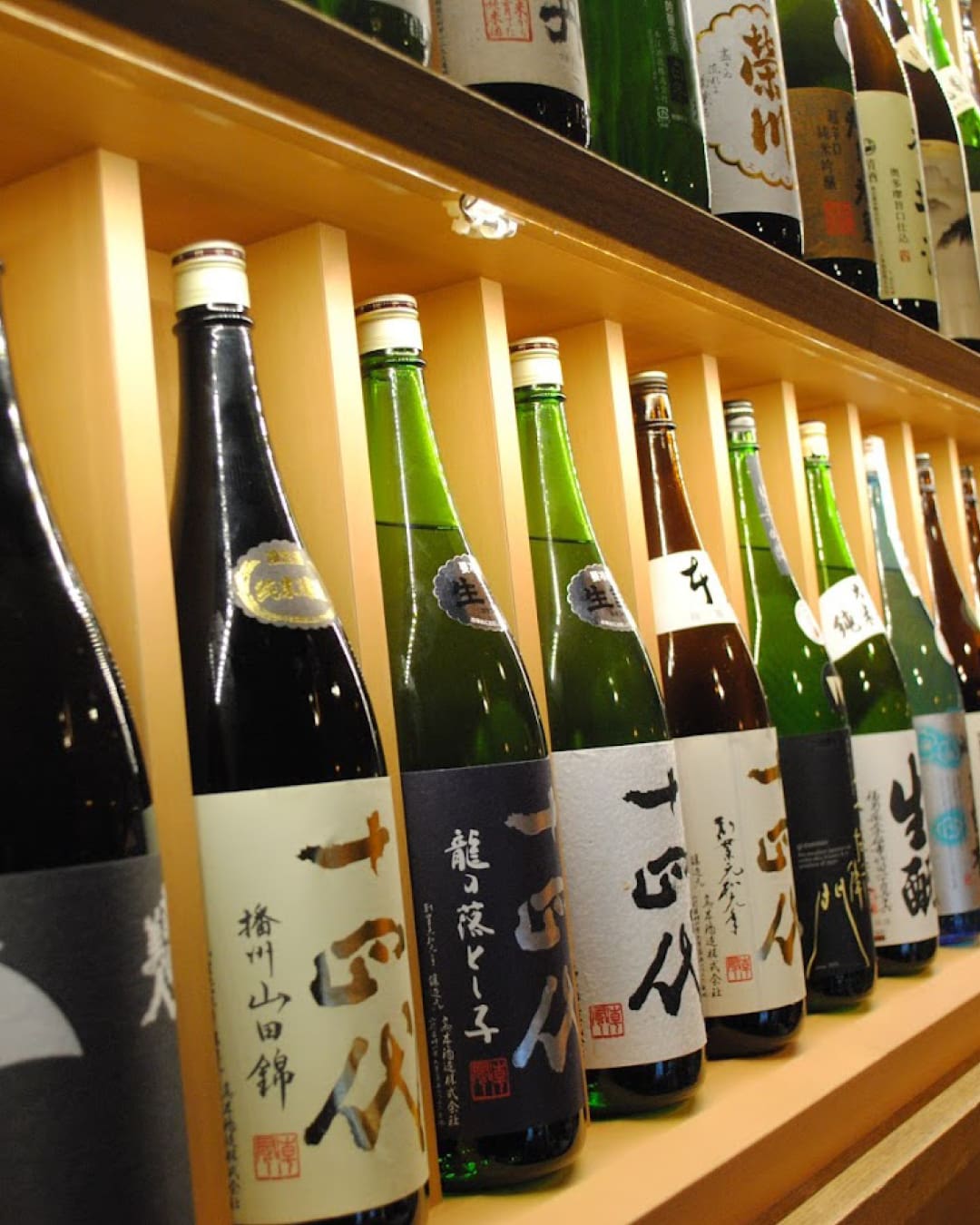 The best izakaya in Tokyo | bottles of sake lined up at Nurukan Sato