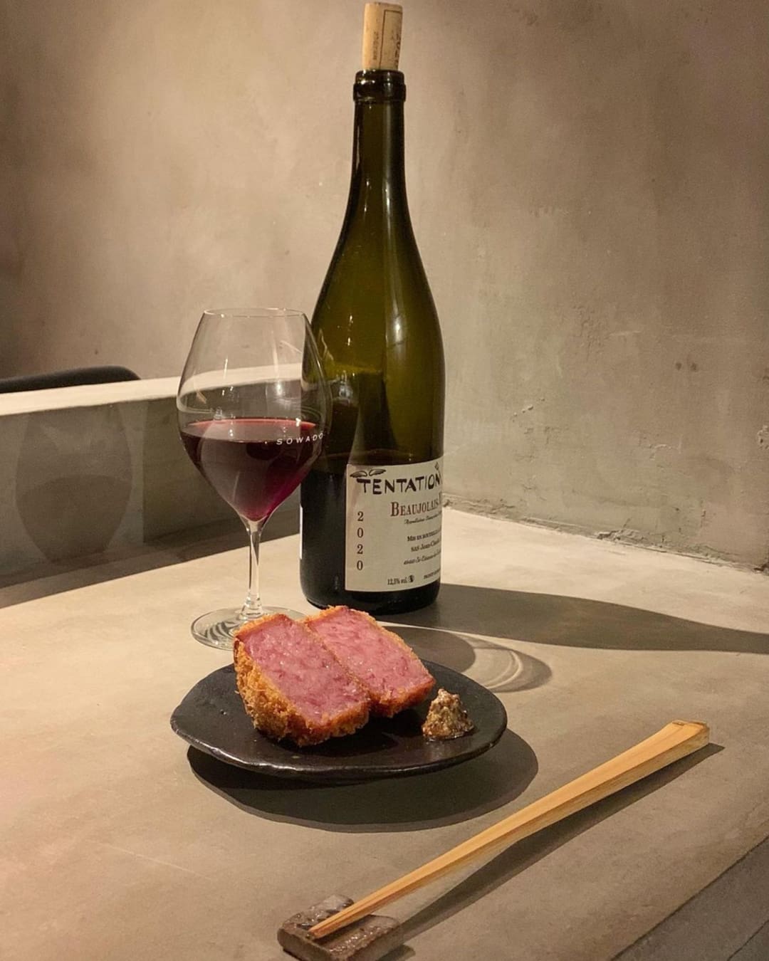 The best izakaya in Tokyo | a meat dish and bottle of natural wine at Sowado