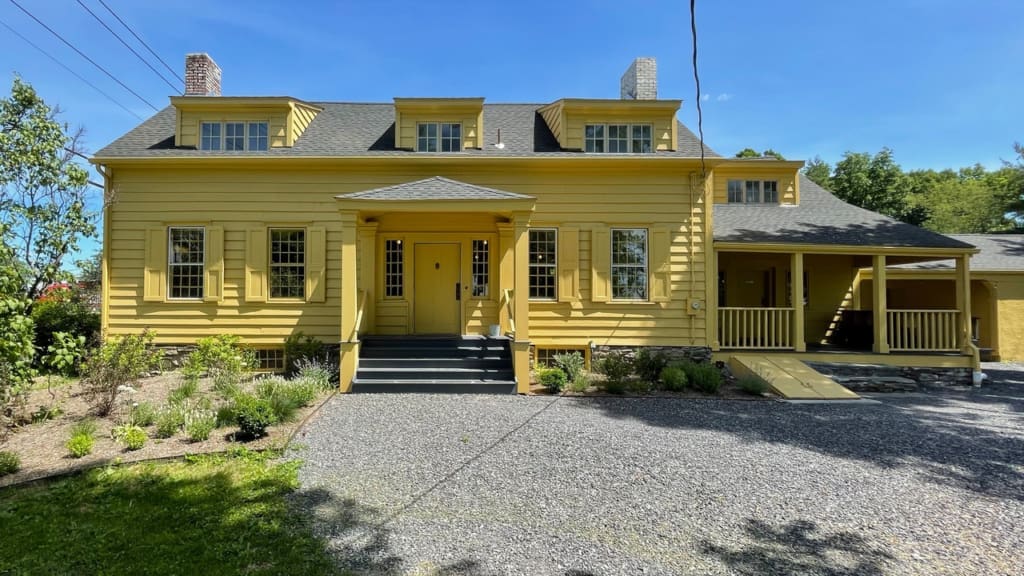 The yellow exterior of Quinnies, set in an 18th century house in Hudson