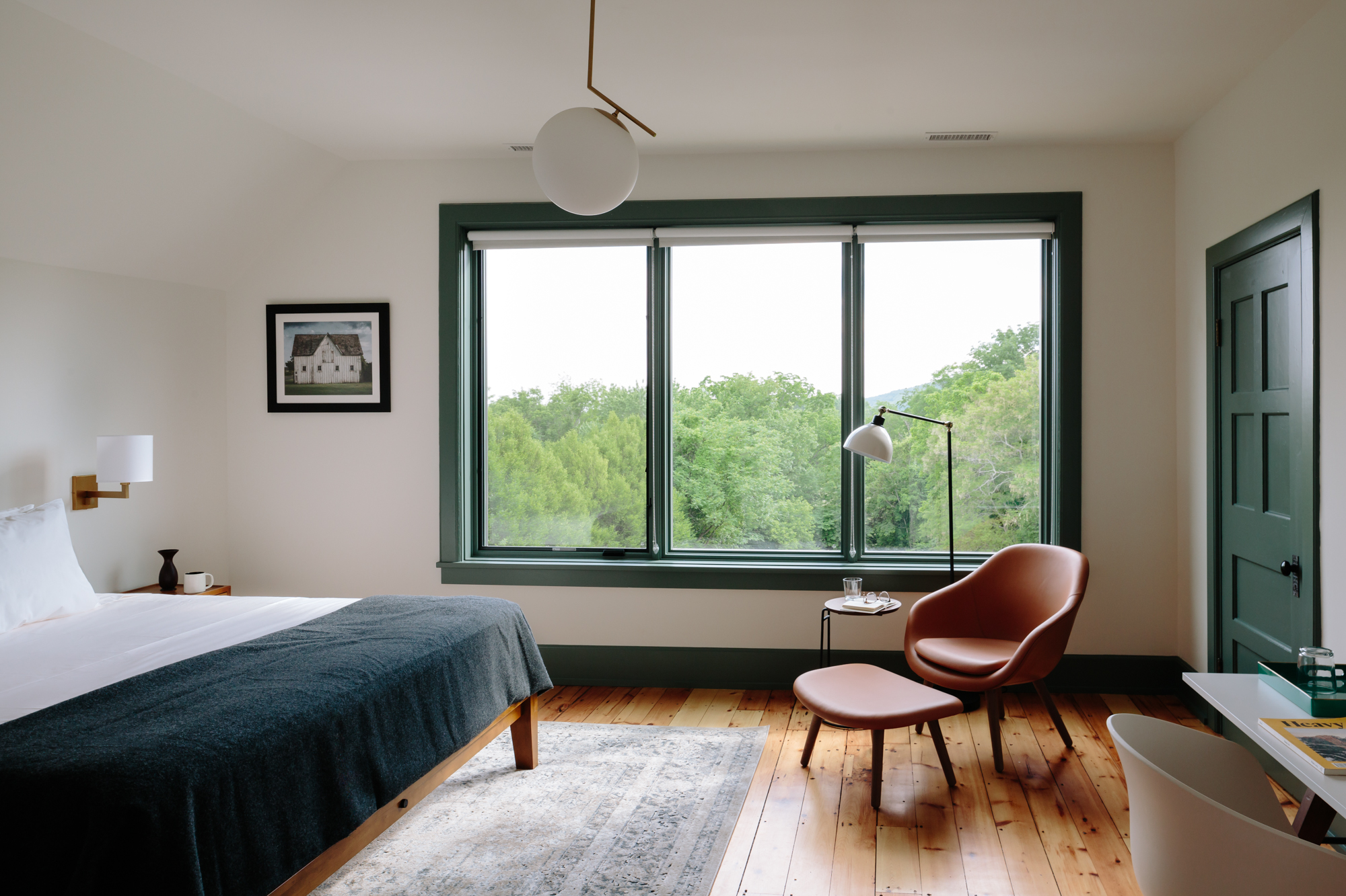 The best hotels in Hudson NY | a bedroom at The Amelia with treetop views