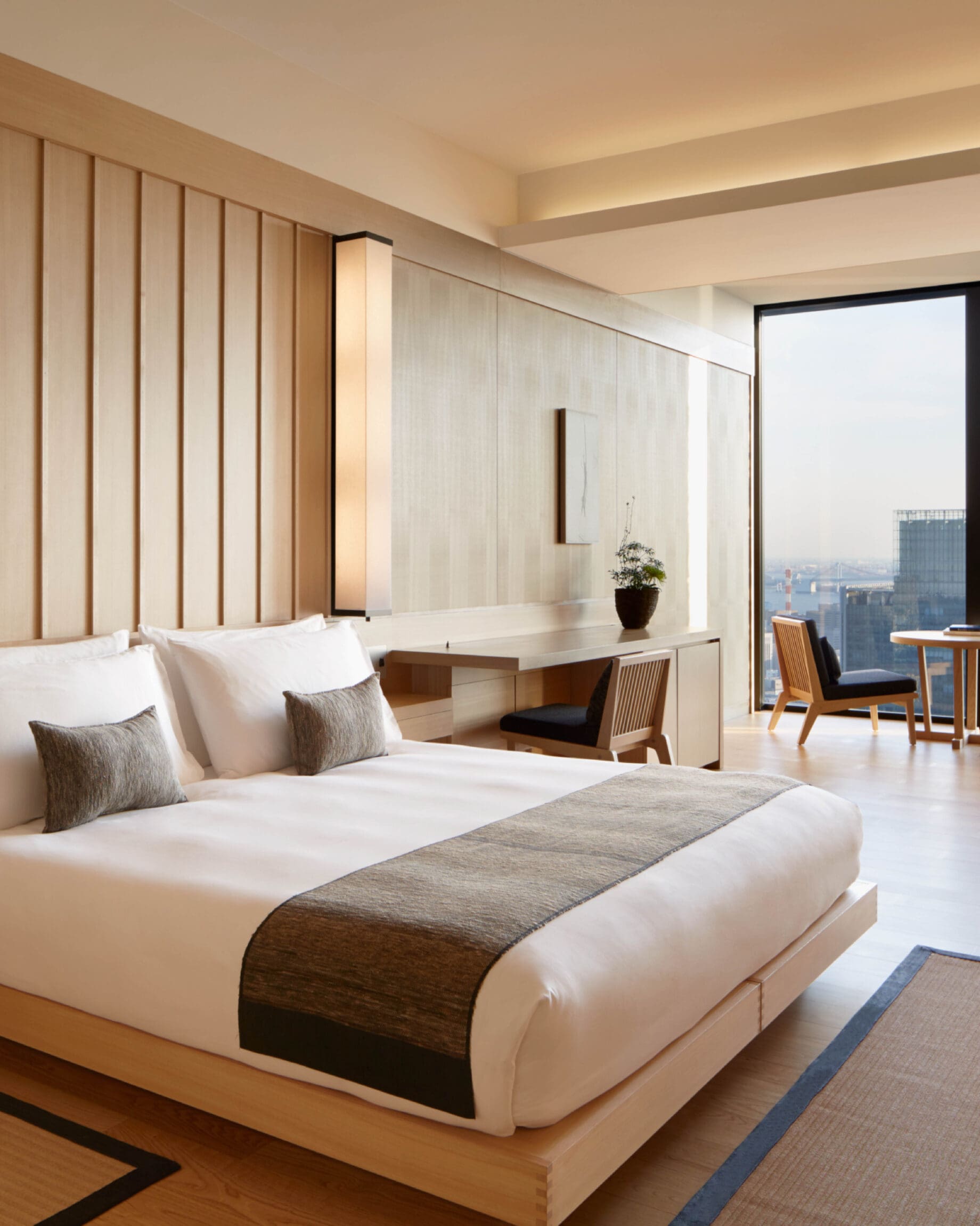 The best hotels in Tokyo | A large bedroom in soothing tones at Aman Tokyo