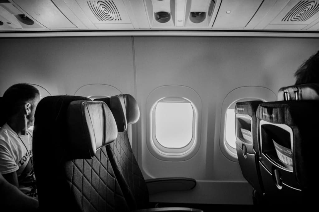 Black and white photo of a plane interior by Josh Withers