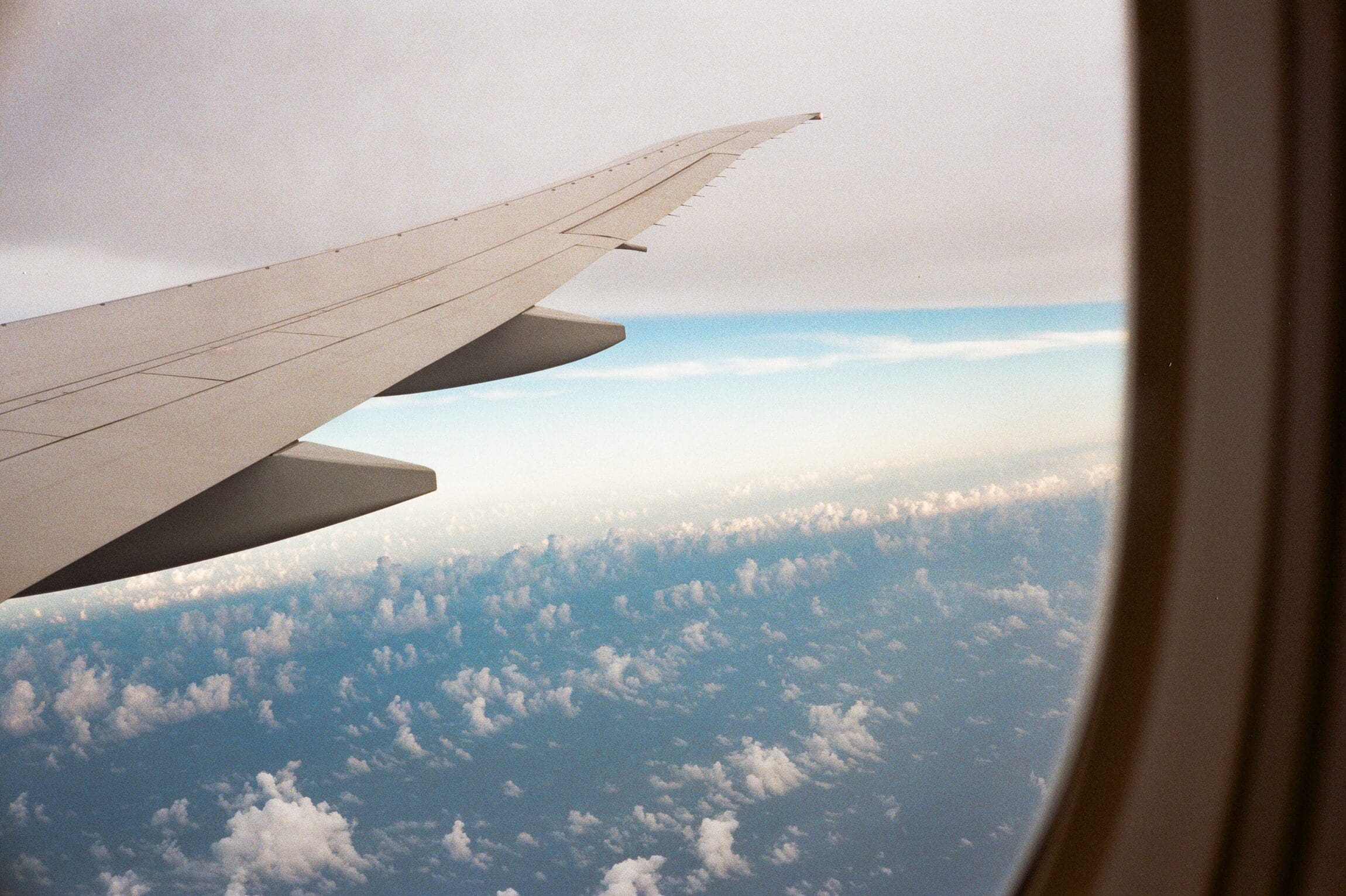 View from an airplane window showing the wing in flight.