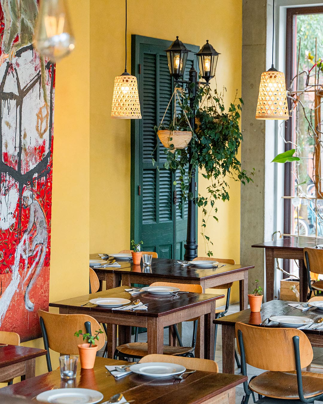 Bright interiors at Papa Thang in Amsterdam Noord: yellow wall, hanging plants