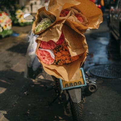 A man on a bike at Pak Khlong Talat (Flower Market)