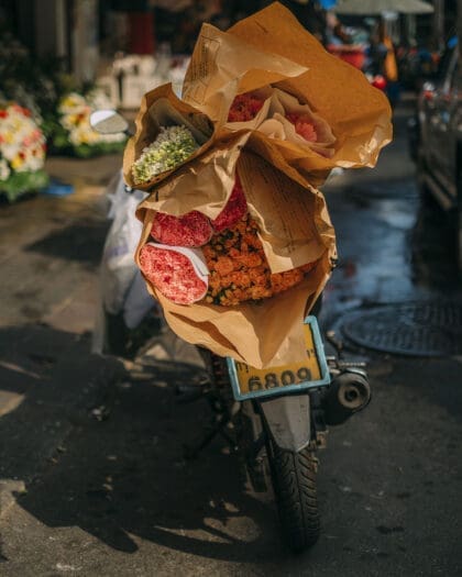 A man on a bike at Pak Khlong Talat (Flower Market)
