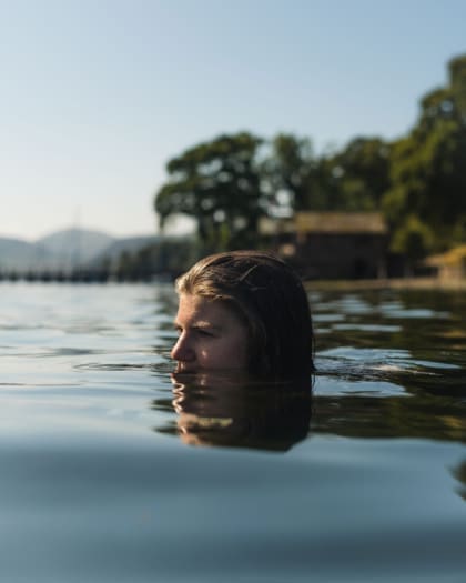 Wellness trends 2024 | a women emerges from a wild swim in the Lake District