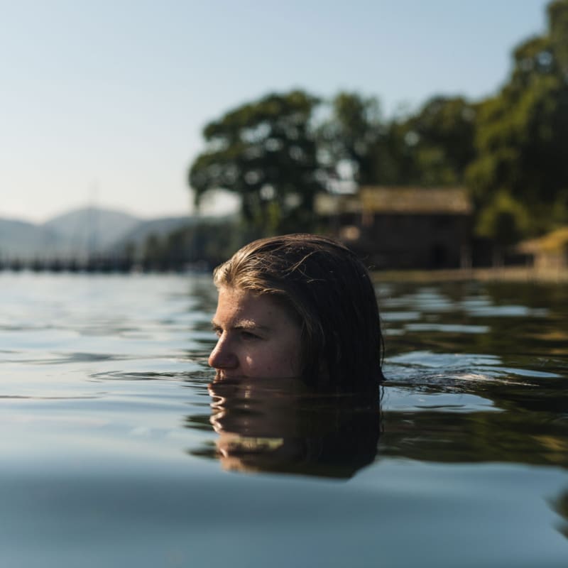 Wellness trends 2024 | a women emerges from a wild swim in the Lake District