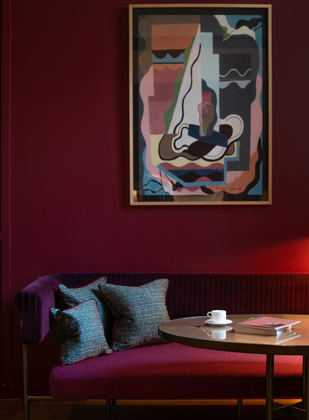 Eastern art against a bright jewel tone wall at Le Ballu in Paris