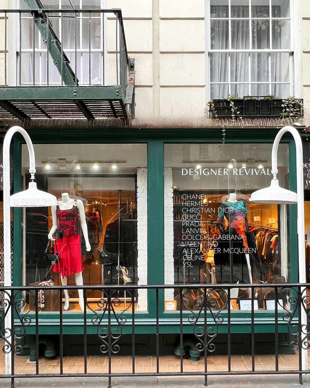 Frontage of Designer Revival, a vintage clothing store in New York. Clothing from well known fashion labels are advertised in the windows