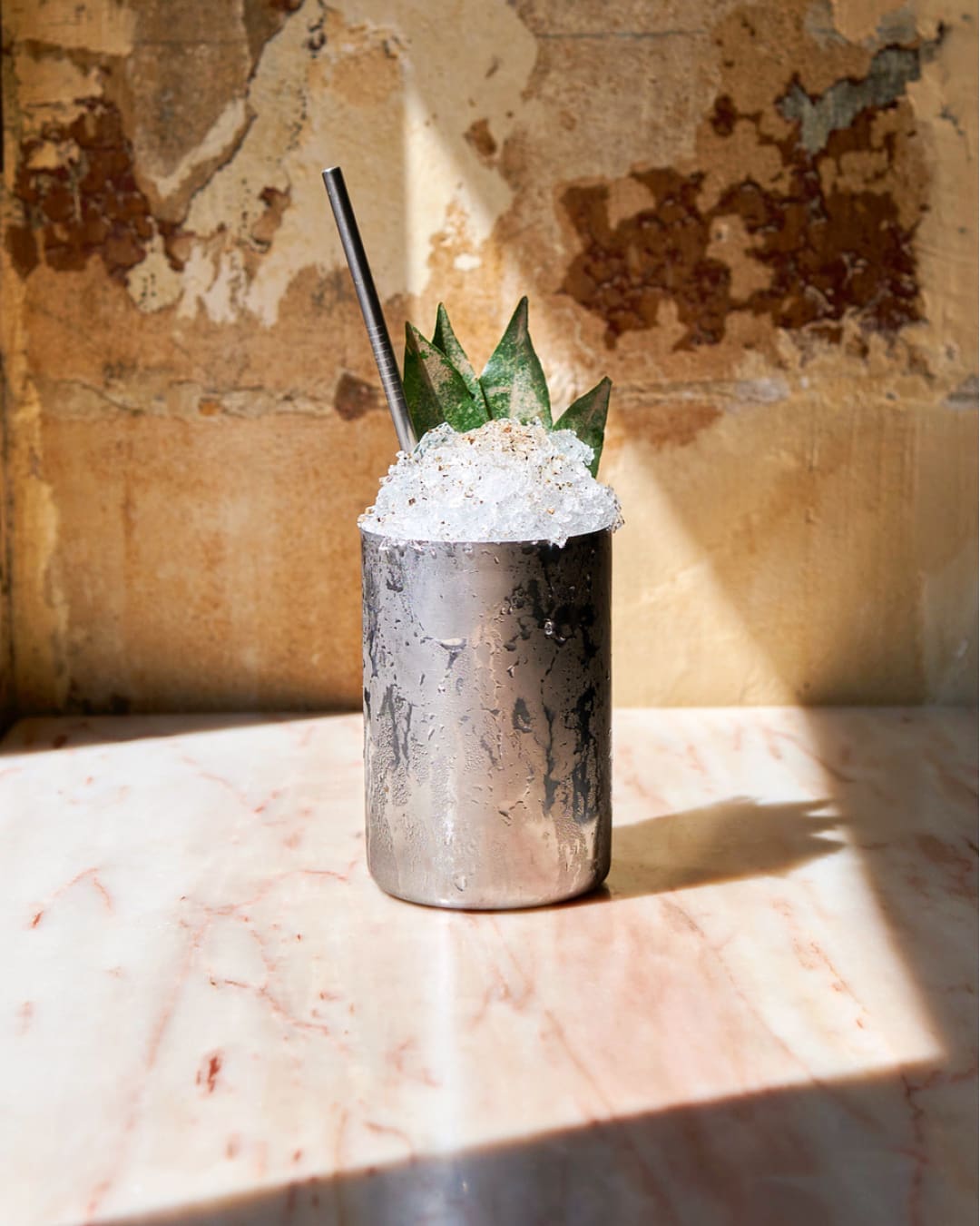 The best cocktail bars in Paris | an iced cocktail at Combat in a tin vessel