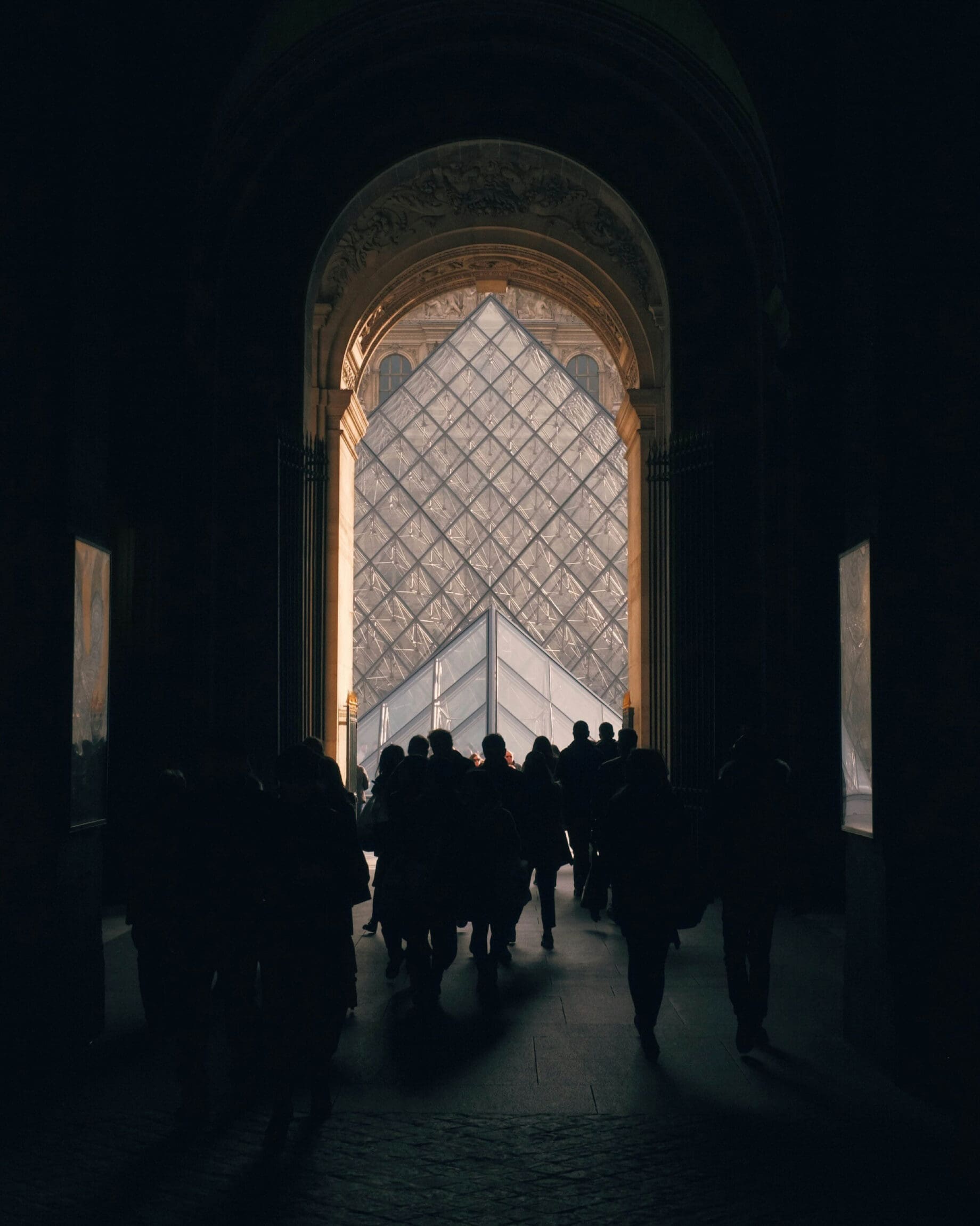 The best art galleries and museums in Paris | An interior view of The Louvre with the glass pyramid visible.