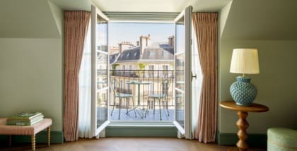 A hotel bedroom in Paris with balcony views