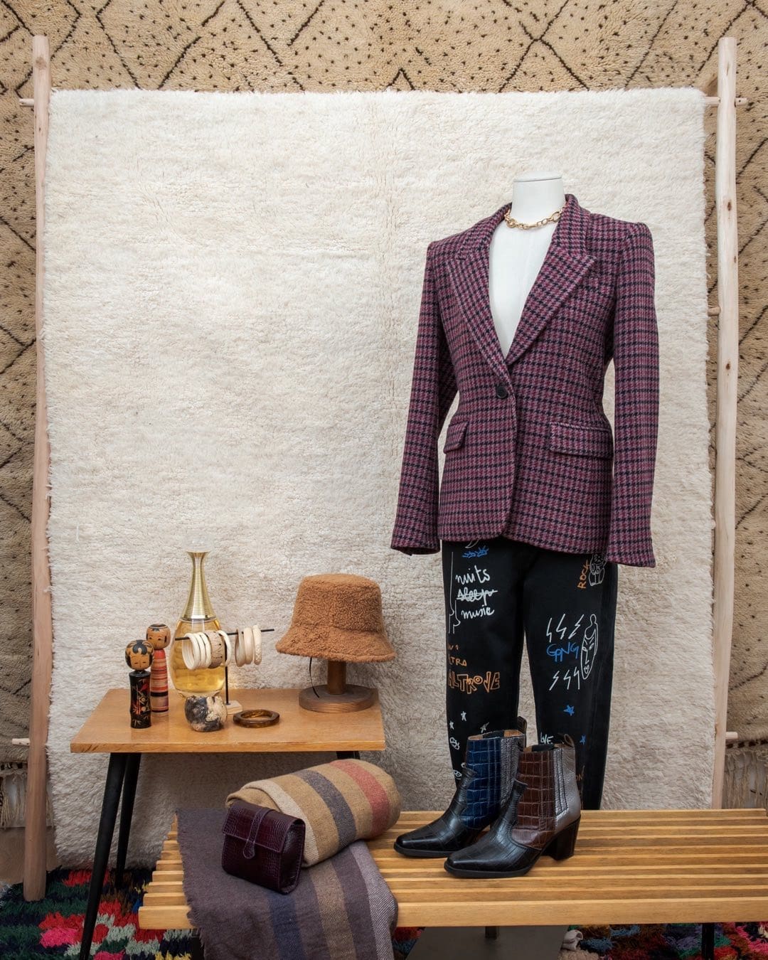 The best vintage shops in Paris | A window display at Nour Paris shows a tailored blazer, beige hat and black boots