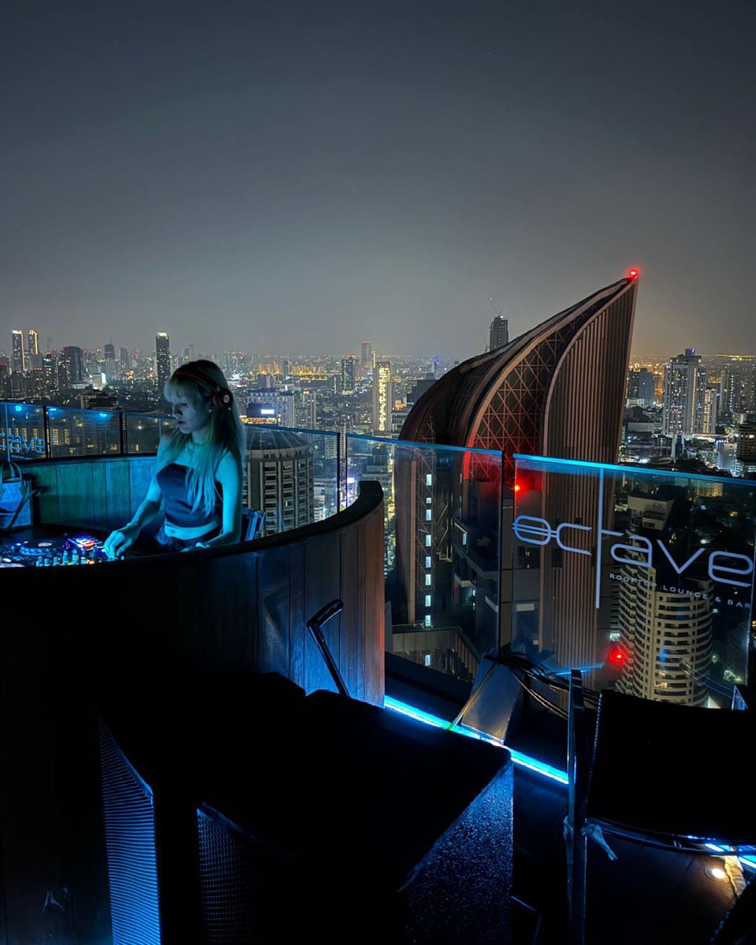 The best restaurants and bars in Bangkok's Thonglor | A DJ performs on Octave Rooftop Lounge & Bar, with views of the Bangkok skyline behind.
