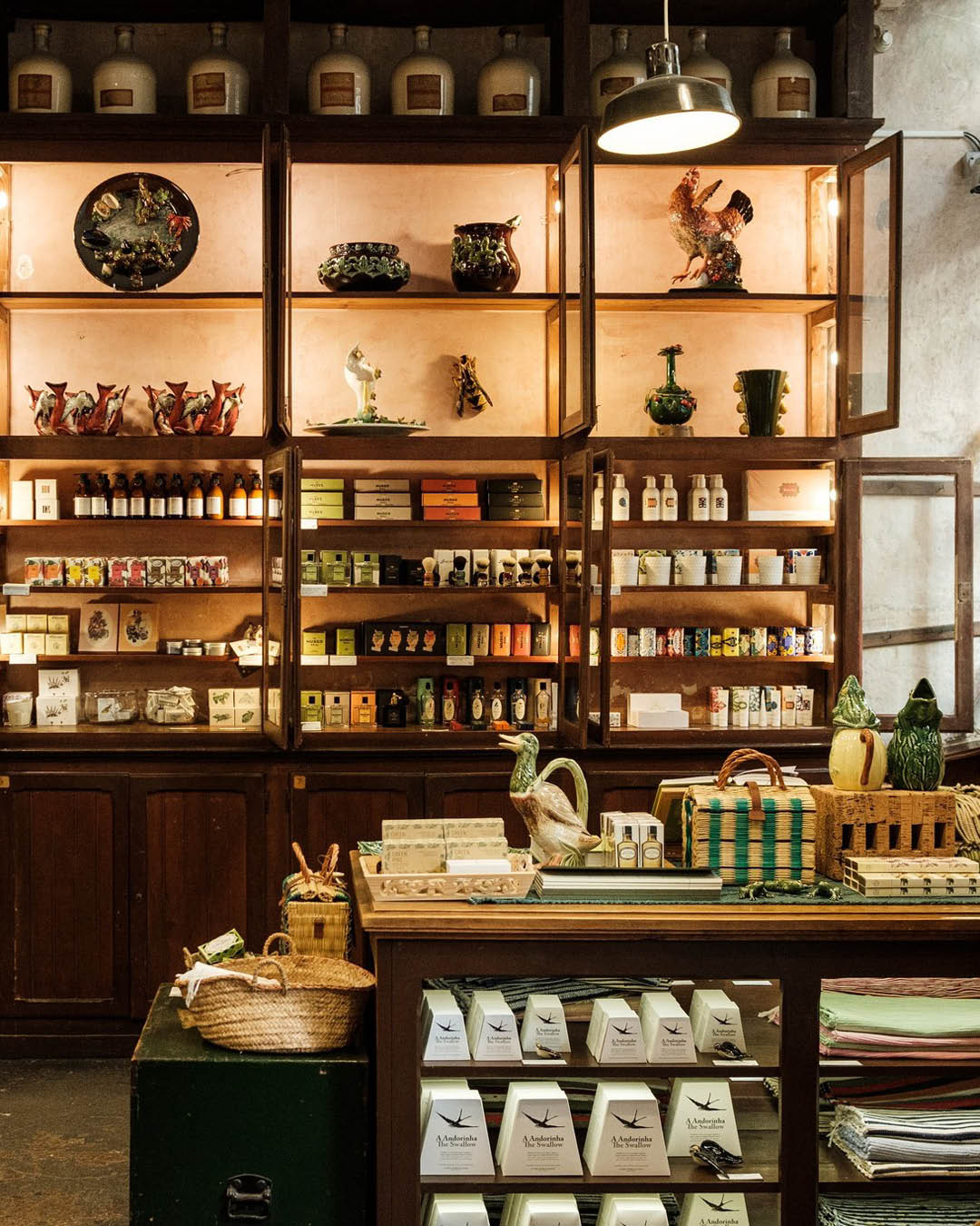 Traditional wooden shelving inside A Vida Portuguesa, a historic candle shop in Lisbon.