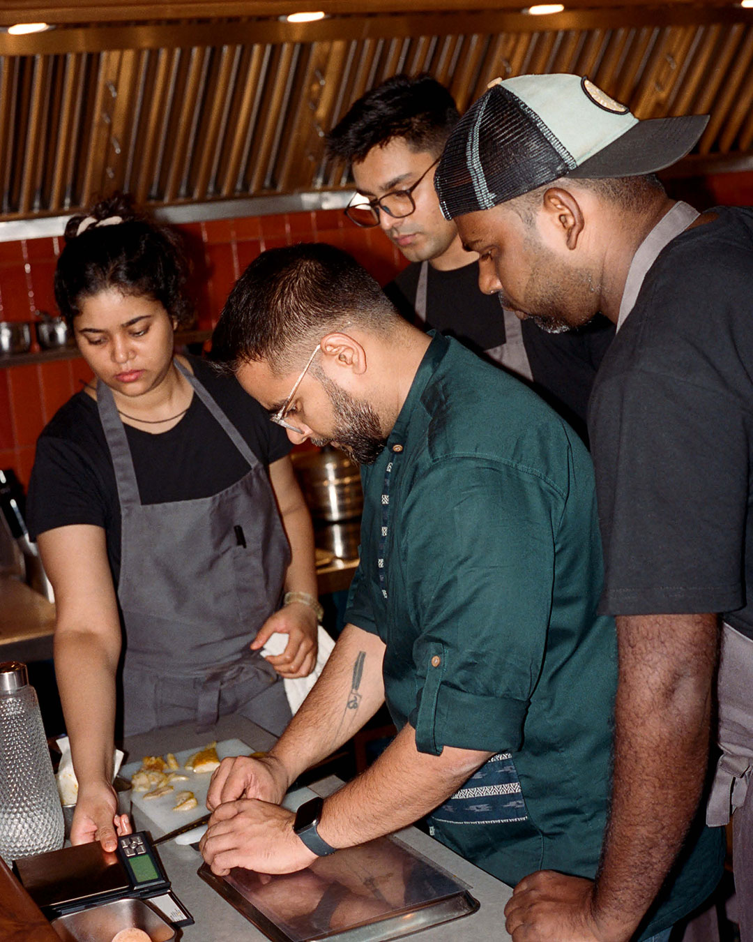 Shahzad working with his team at his new chef’s counter space Papa’s.