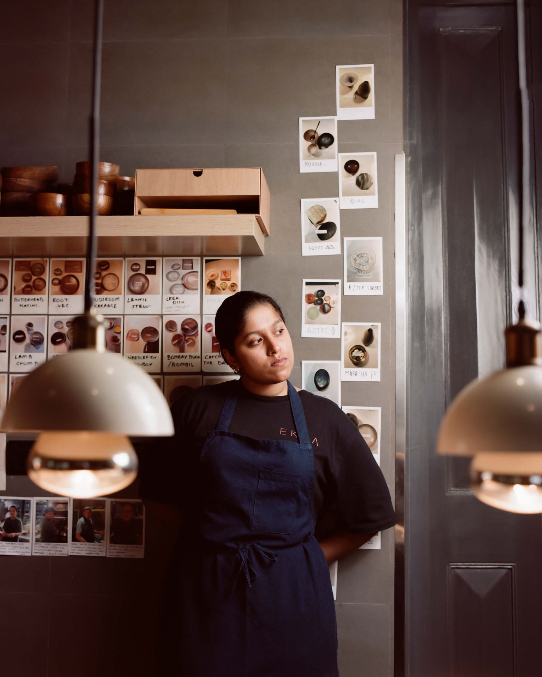 Niyati Rao, chef and co-owner of Ekaa, leaning against a wall in the restaurant.