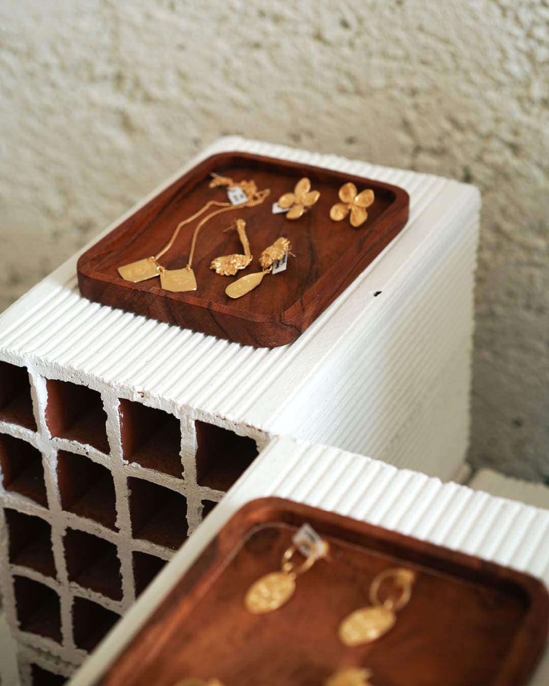 Jewellery on display on small wooden trays at Mustique shop in Lisbon