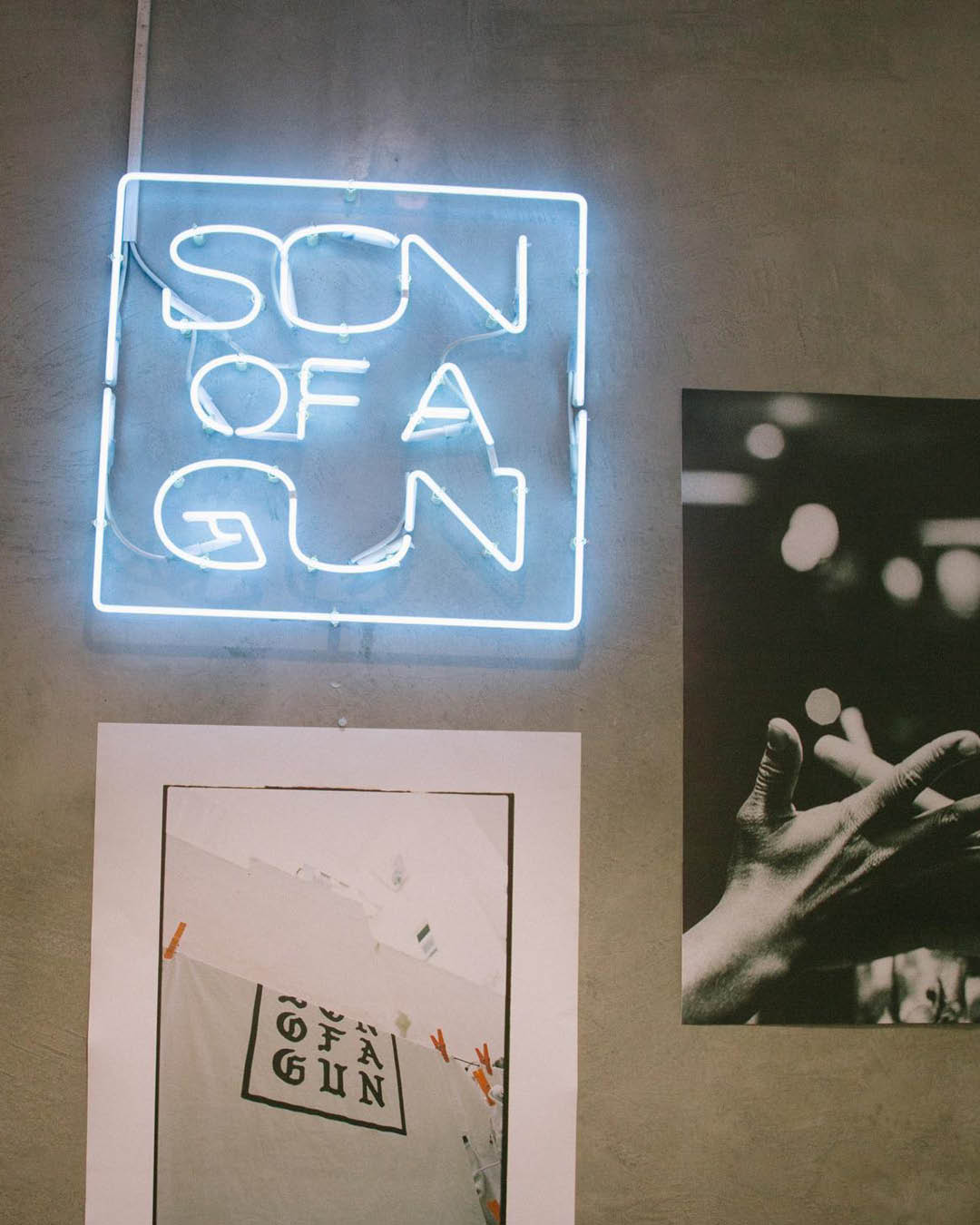 An interior detail of Son of a Gun shop in Lisbon, including a neon blue sign of their name.