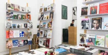 Modern airy bookshop showcasing extensive selection of magazines and publications on shelves