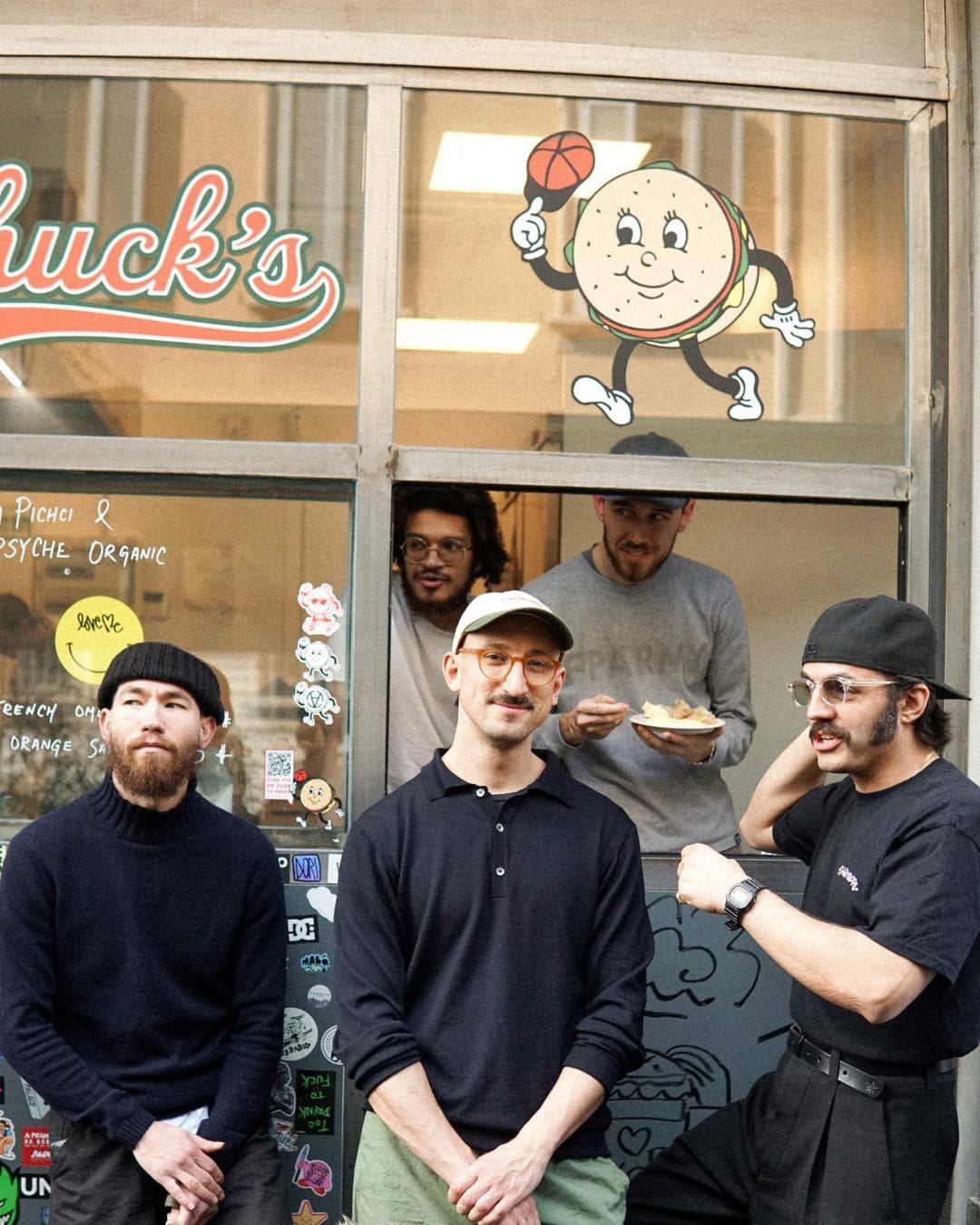 Men laugh outside Chuck's burger joint at Sidewalk Kitchens in Milan