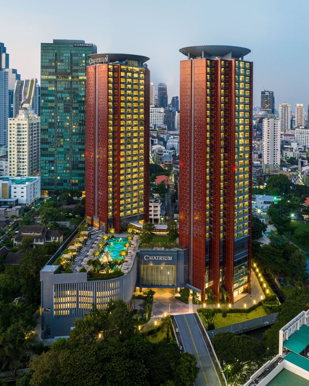 Building scape of twin hotel towers and pool deck of Chatrium Grand Bangkok