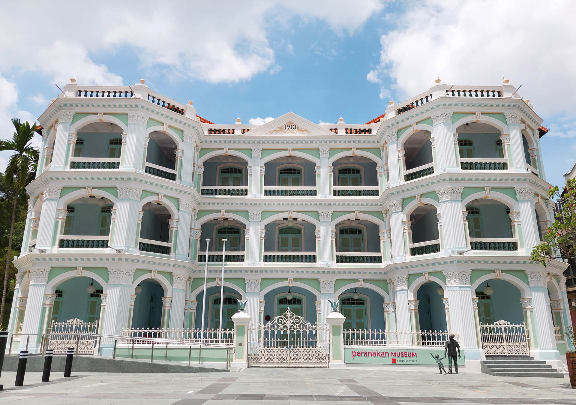 The historic white facade of the Peranakan Museum in Singapore.