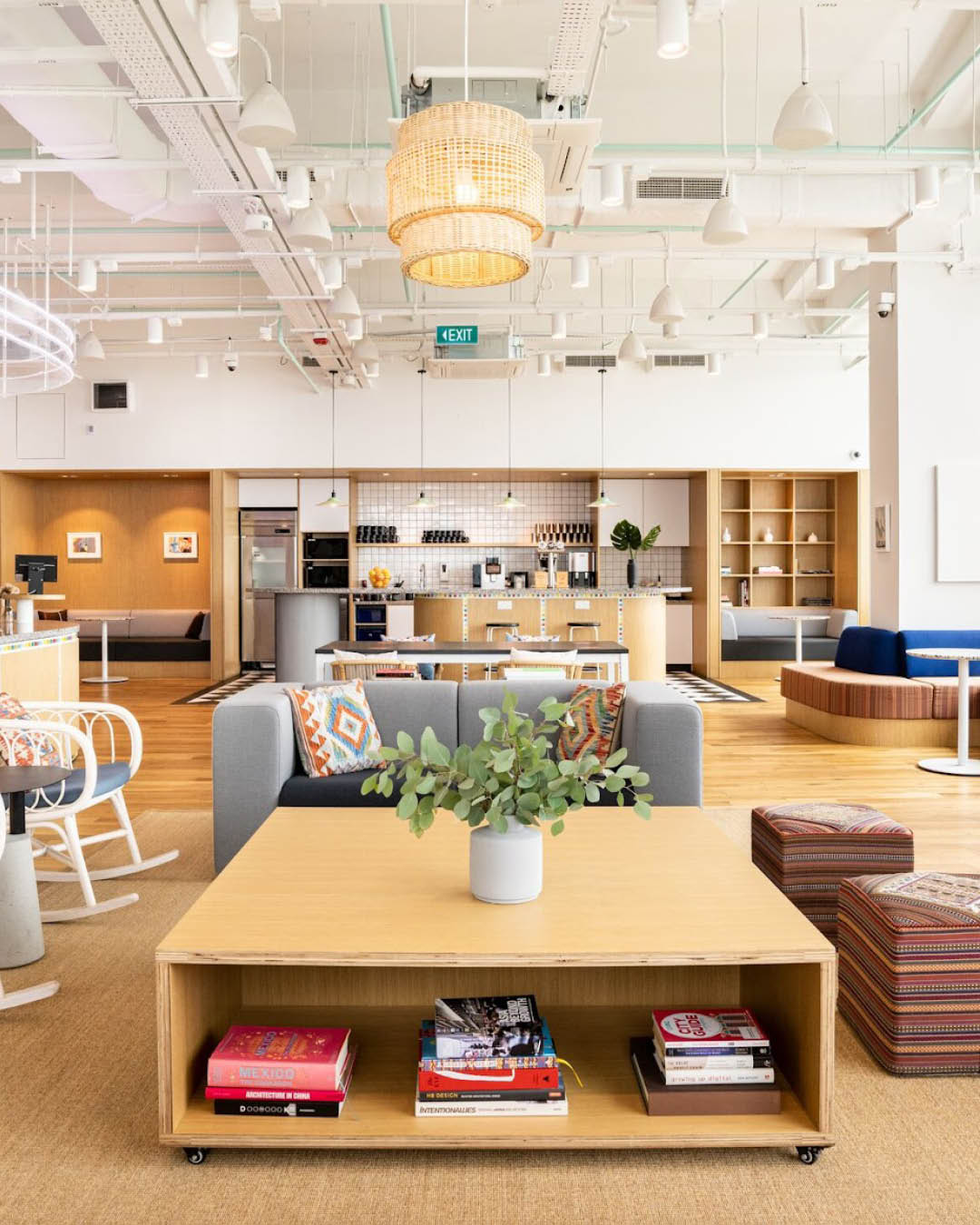 A sofa, coffee table and kitchen area at WeWork, 380 Jalan Besar in Singapore.